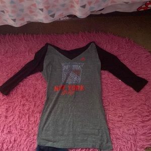 It’s a gray shirt with the top black and it’s size medium